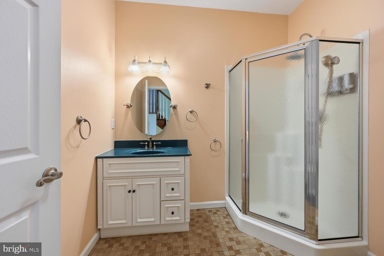 2576 Hoopers Island Road Fishing Creek, MD 21634 - Photo 20 of 43 a bathroom with a granite countertop shower a mirror and a sink