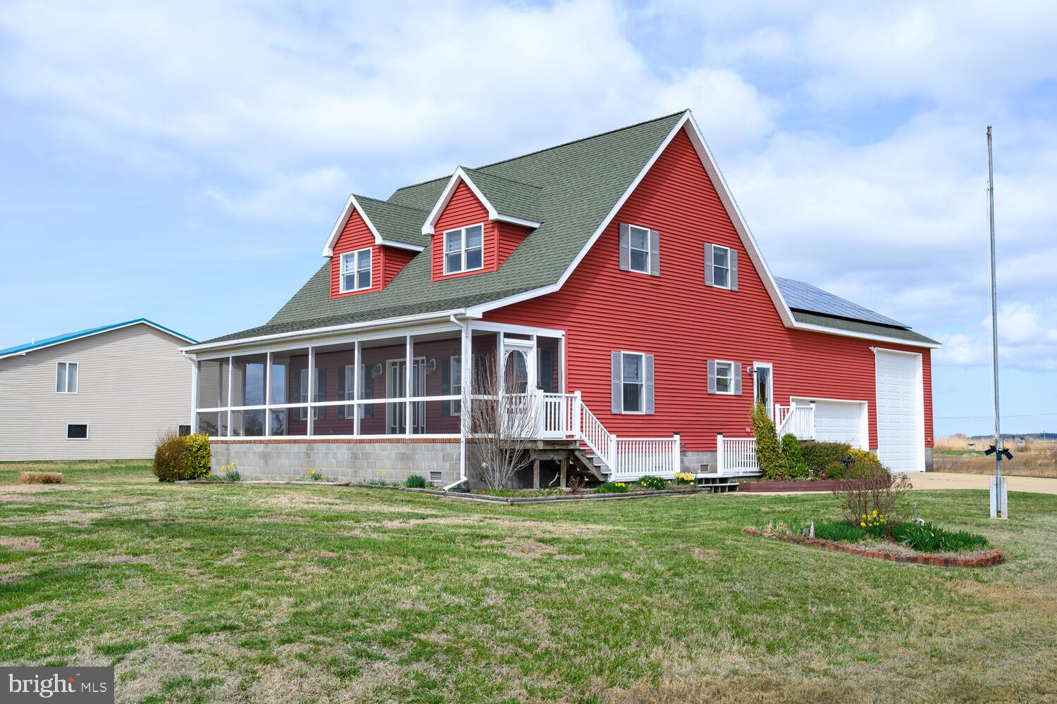 2576 Hoopers Island Road Fishing Creek, MD 21634 - Photo 2 of 43 a front view of a house with a yard and garage
