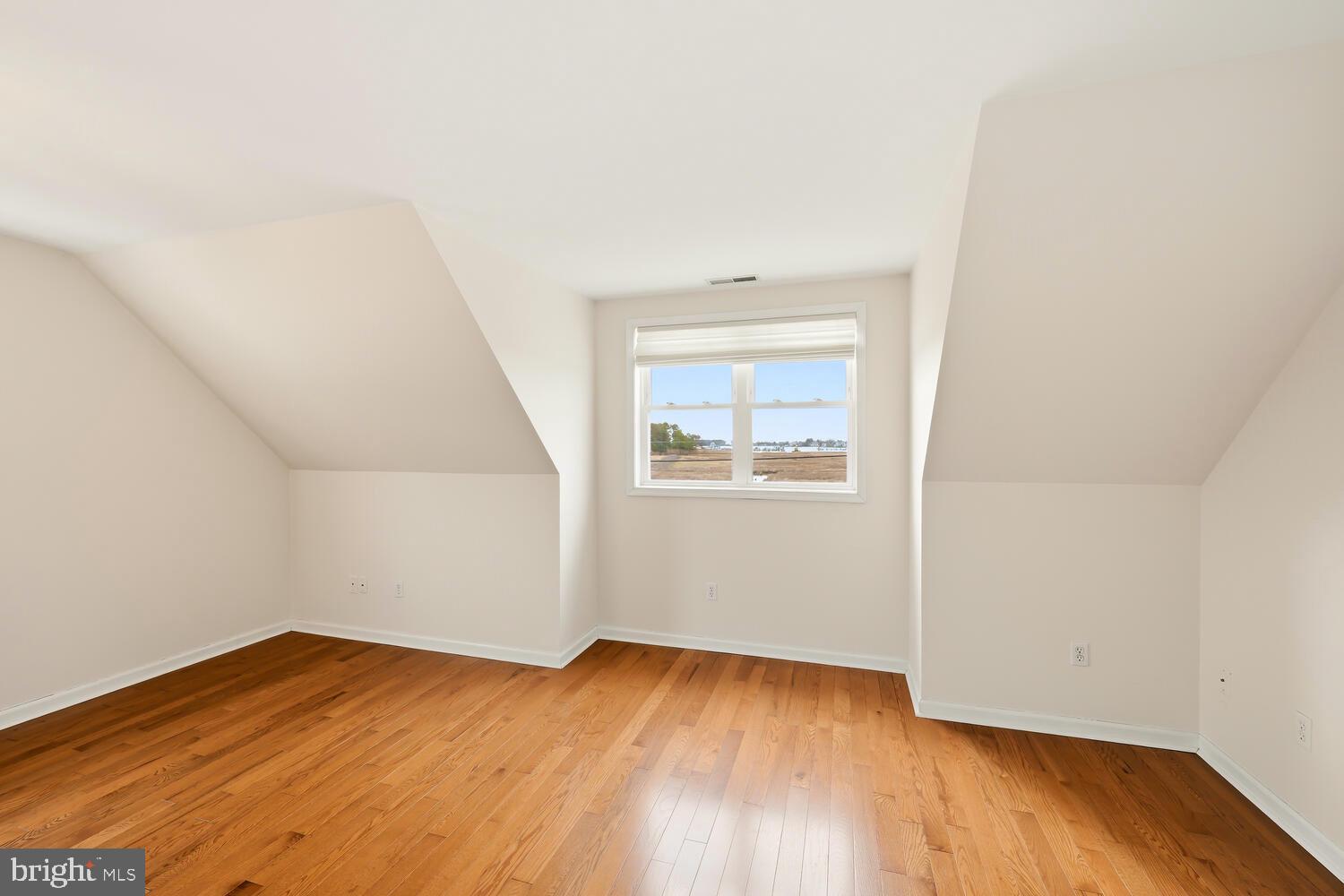 2576 Hoopers Island Road Fishing Creek, MD 21634 - Photo 23 of 43 an empty room with wooden floor and windows
