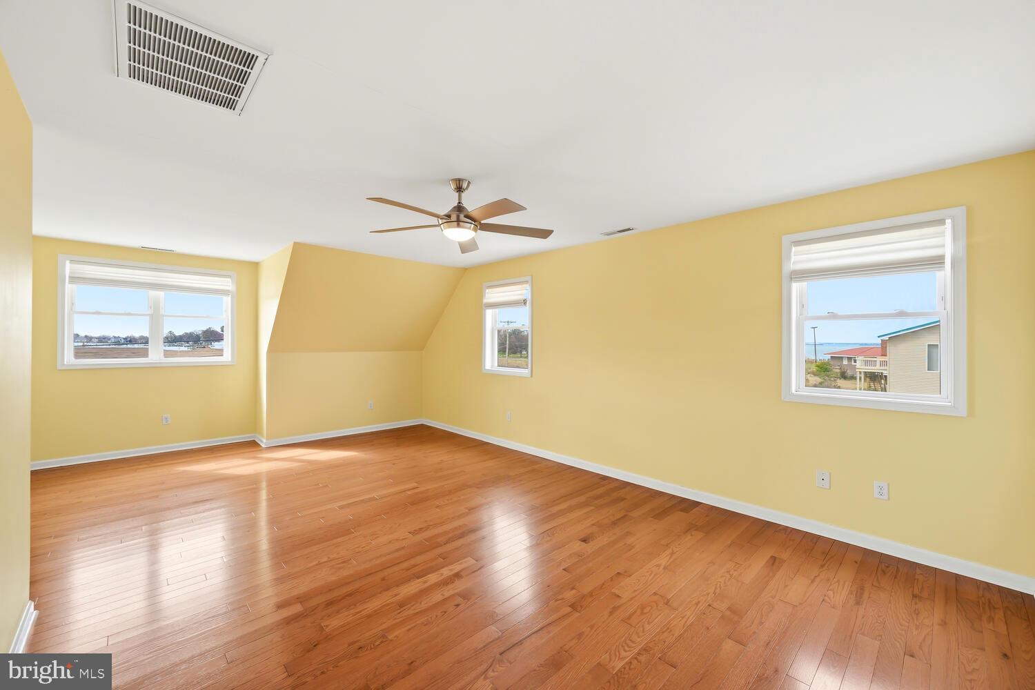 2576 Hoopers Island Road Fishing Creek, MD 21634 - Photo 26 of 43 a view of an empty room with wooden floor and a window