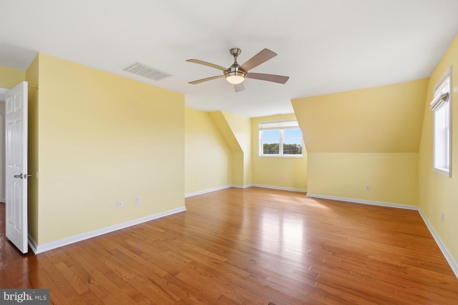 2576 Hoopers Island Road Fishing Creek, MD 21634 - Photo 28 of 43 a view of a big room with wooden floor and a ceiling fan