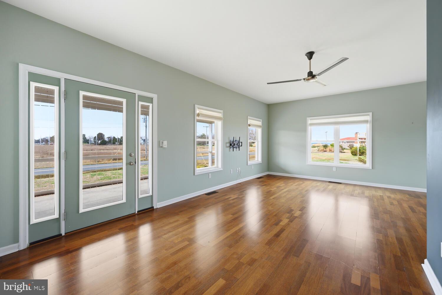 2576 Hoopers Island Road Fishing Creek, MD 21634 - Photo 5 of 43 a view of an empty room with wooden floor and a window