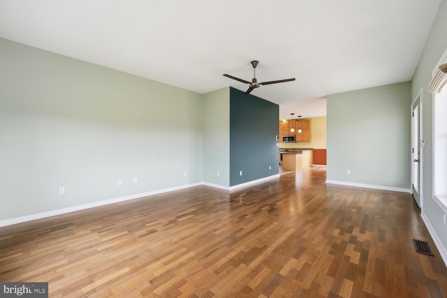 2576 Hoopers Island Road Fishing Creek, MD 21634 - Photo 8 of 43 a view of empty room with wooden floor and ceiling fan