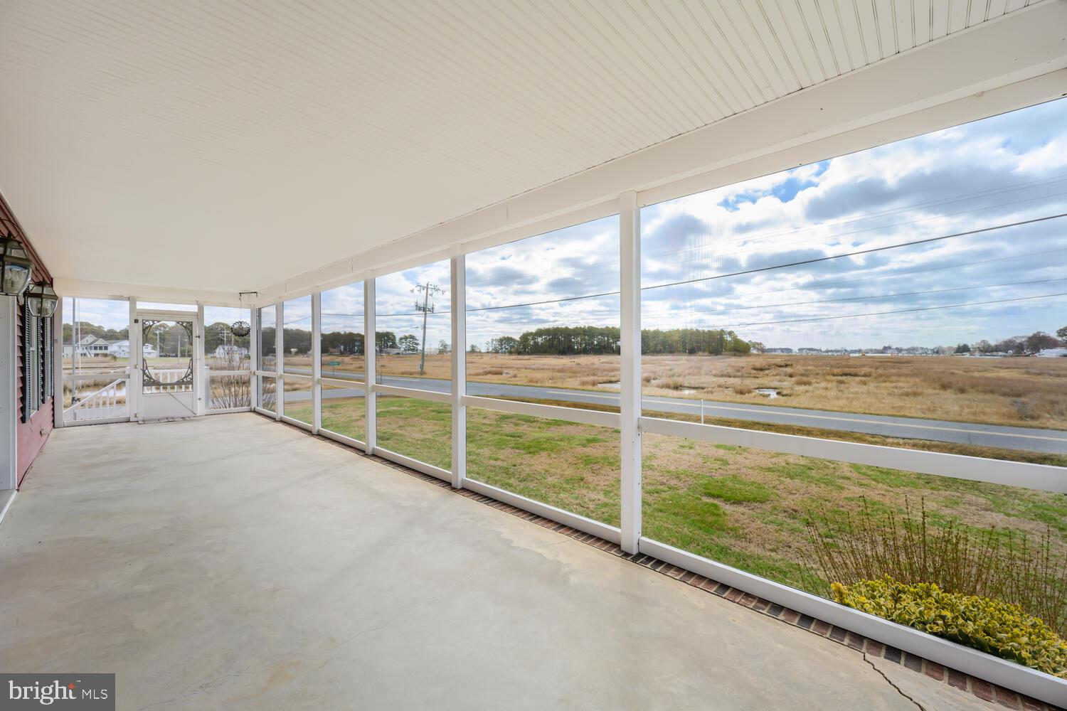 2576 Hoopers Island Road Fishing Creek, MD 21634 - Photo 10 of 43 a view of an empty room with floor to ceiling windows