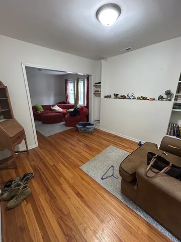 a bedroom with furniture and a wooden floor