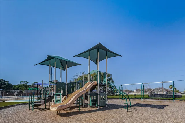 a view of an house with swimming pool garden and trees
