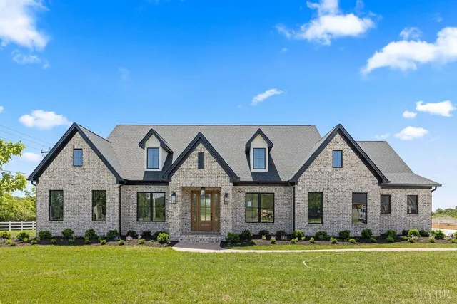 a front view of house with yard and green space