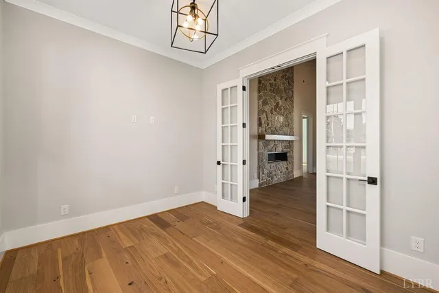 a view of a kitchen with white cabinets and wooden floor