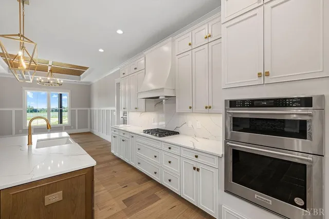 a bathroom with a double vanity sink toilet mirror and bathtub