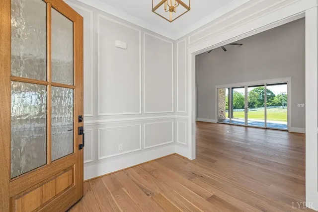 a view of empty room with a fireplace and wooden floor