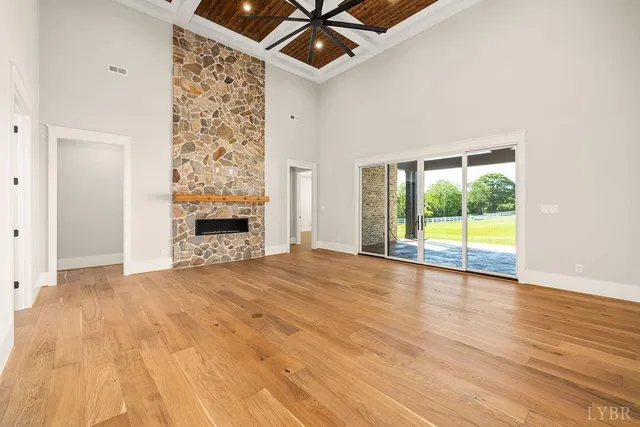 a kitchen with a stove and a wooden floor