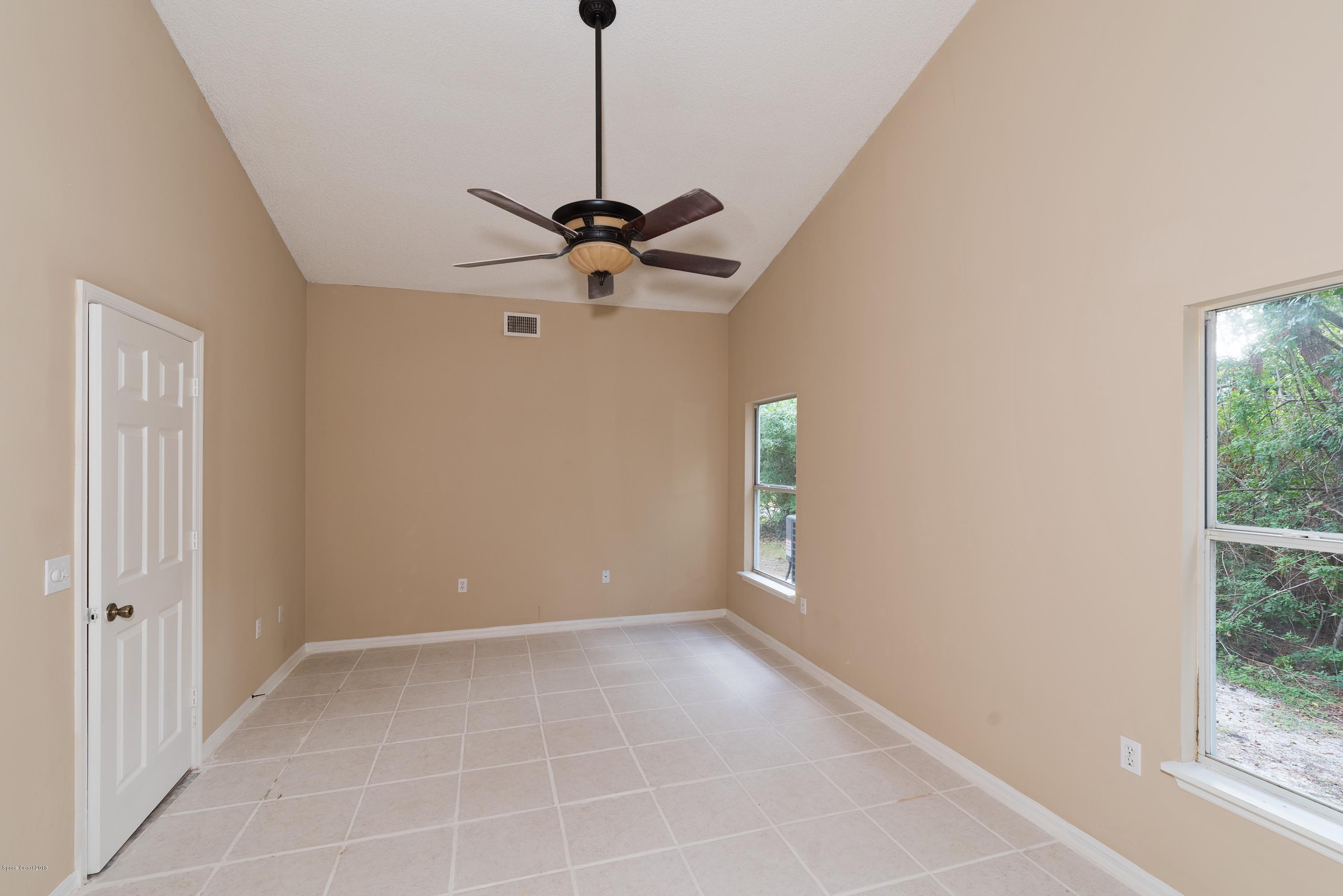1208 Stadt Road Northwest Palm Bay, FL 32907 - Photo 11 of 24 a view of a chandelier fan and a window in a room