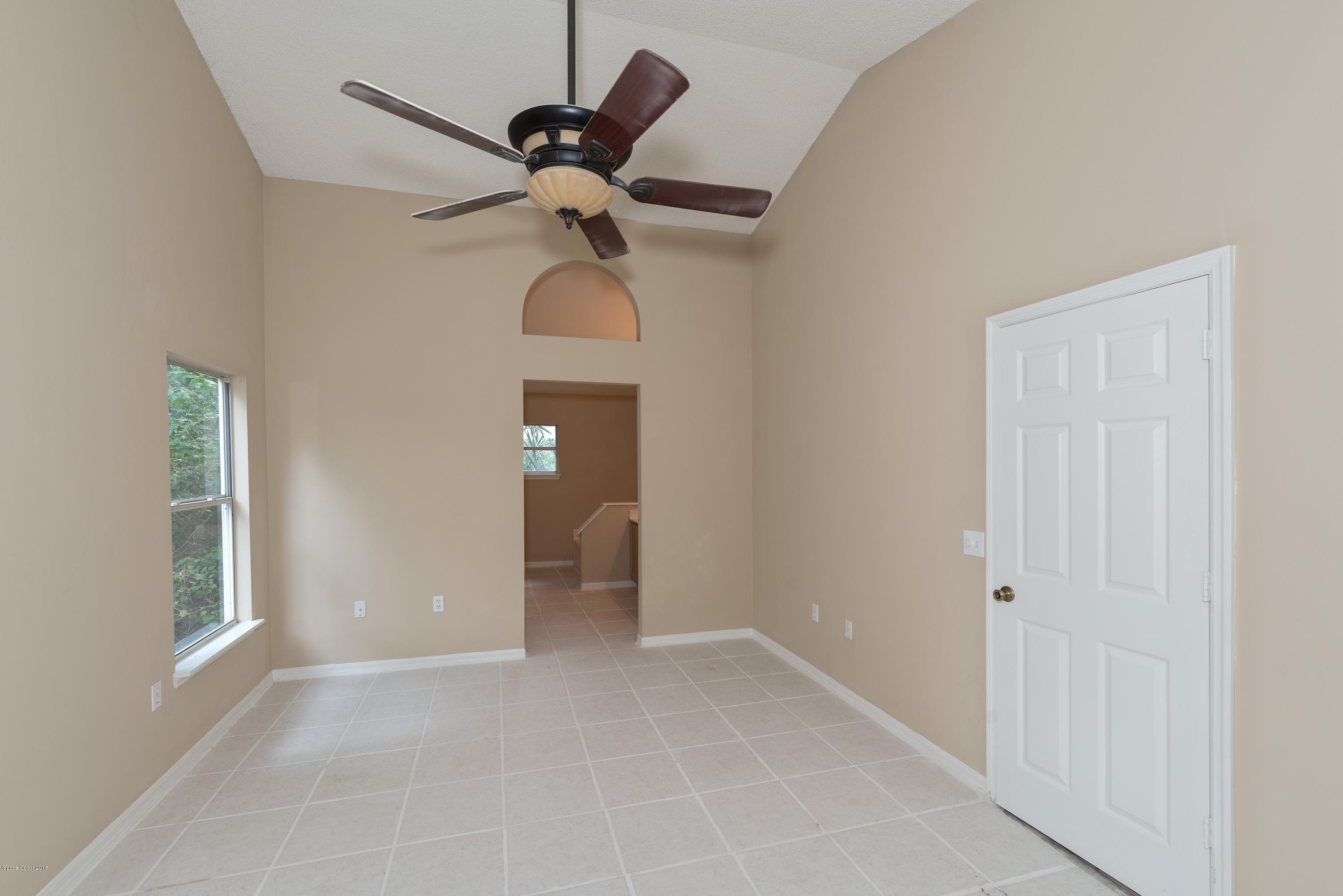 1208 Stadt Road Northwest Palm Bay, FL 32907 - Photo 12 of 24 a view of a room with a ceiling fan and a window
