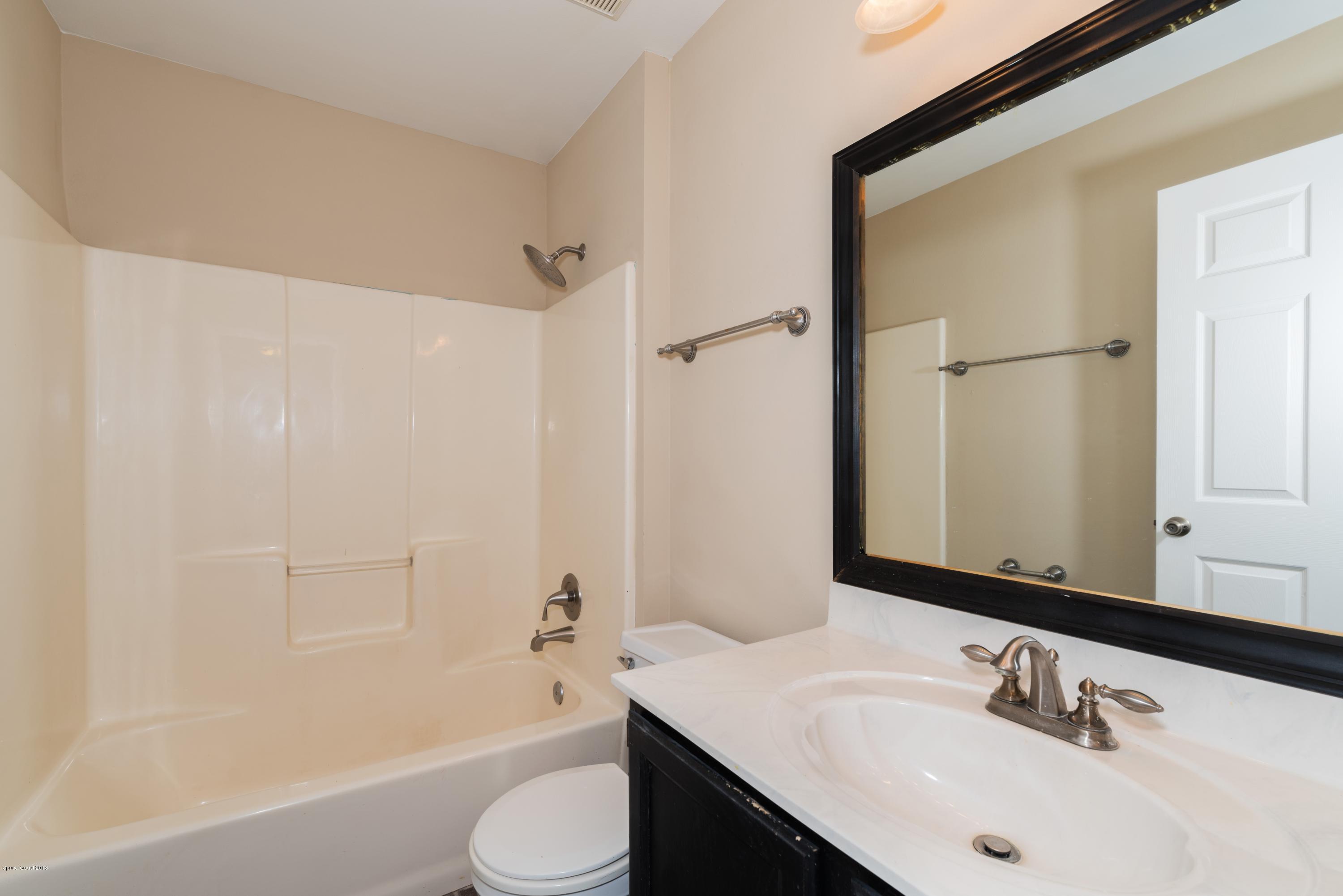 1208 Stadt Road Northwest Palm Bay, FL 32907 - Photo 17 of 24 a bathroom with a sink toilet and shower