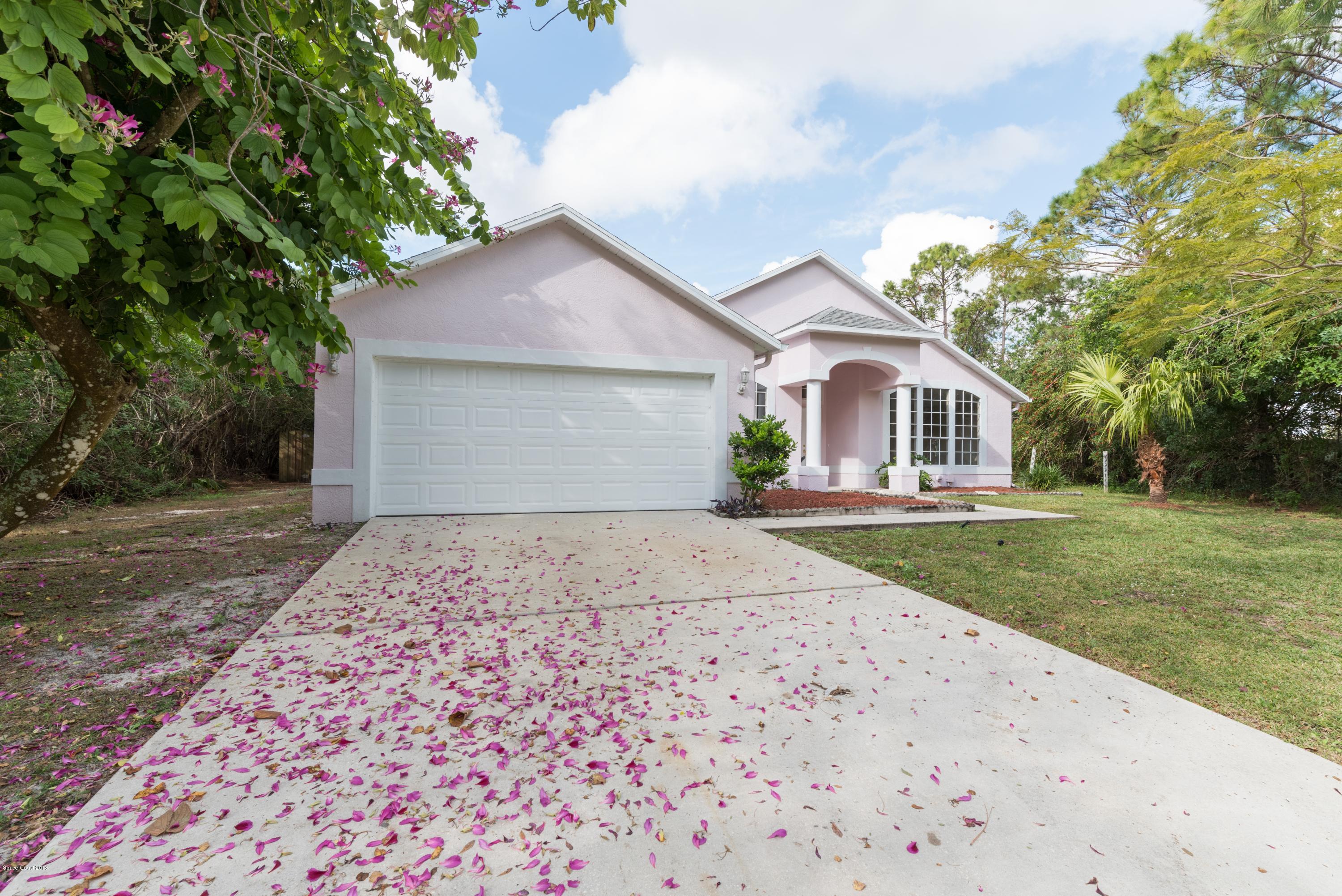 1208 Stadt Road Northwest Palm Bay, FL 32907 - Photo 24 of 24 a front view of a house with a garden and yard