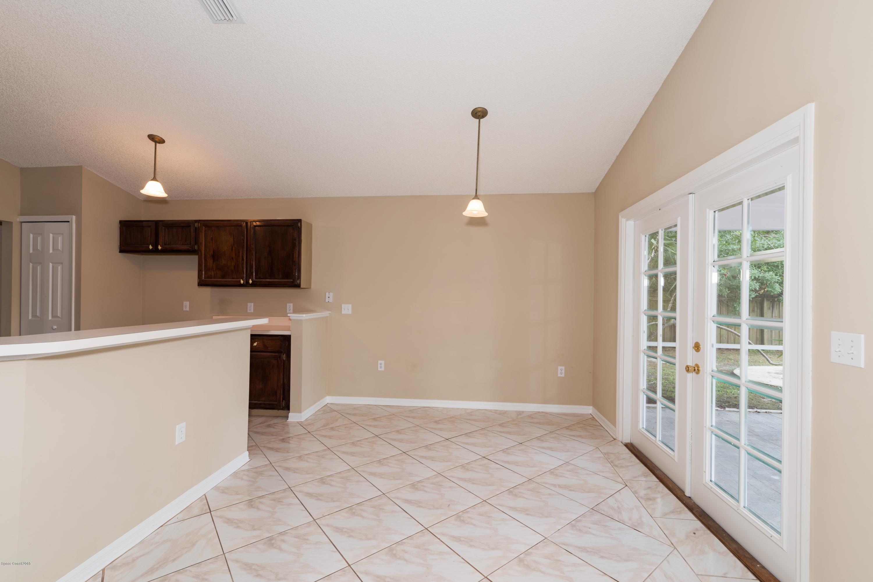 1208 Stadt Road Northwest Palm Bay, FL 32907 - Photo 8 of 24 a view of a kitchen with microwave and refrigerator