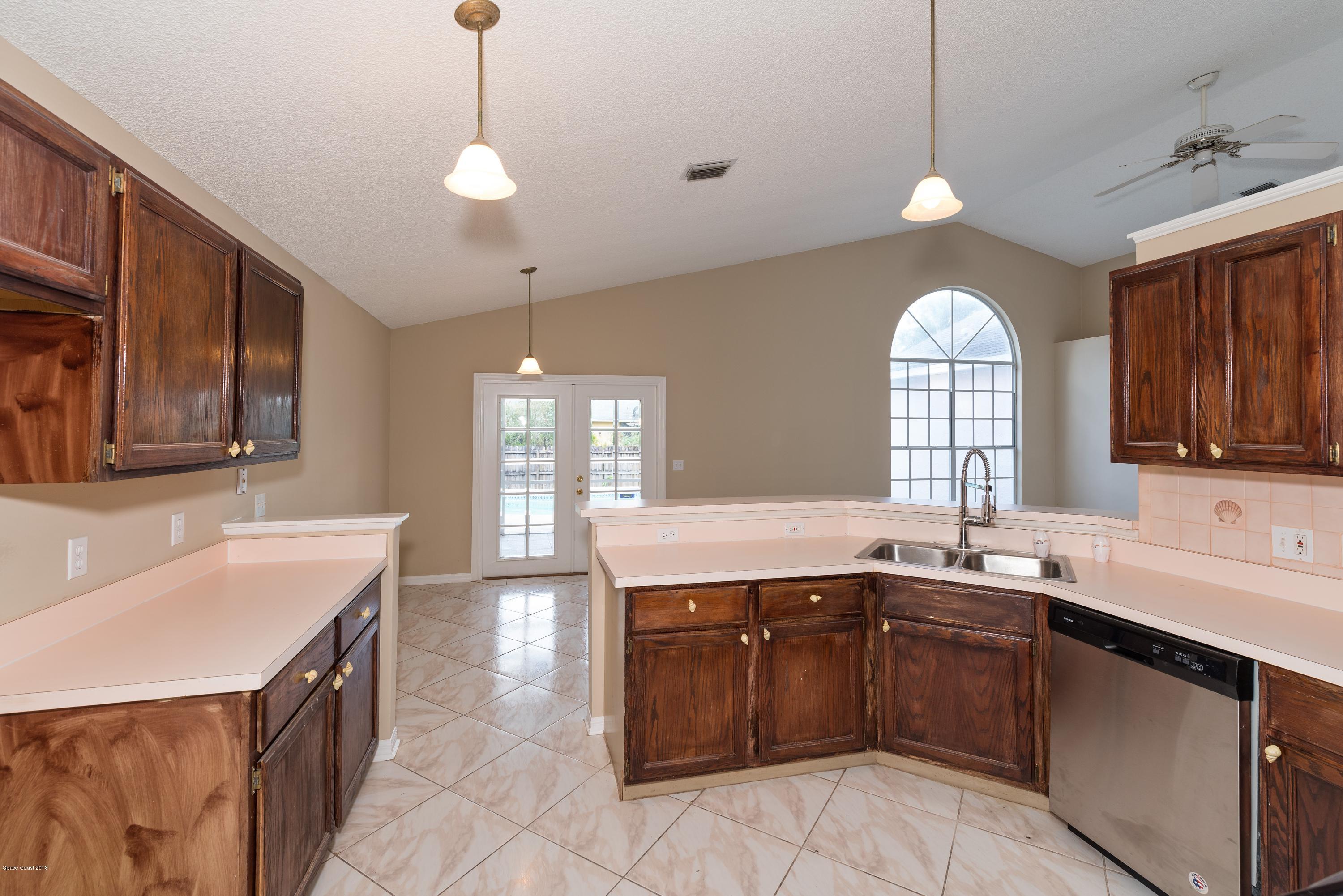 1208 Stadt Road Northwest Palm Bay, FL 32907 - Photo 10 of 24 a kitchen with a sink stove and cabinets
