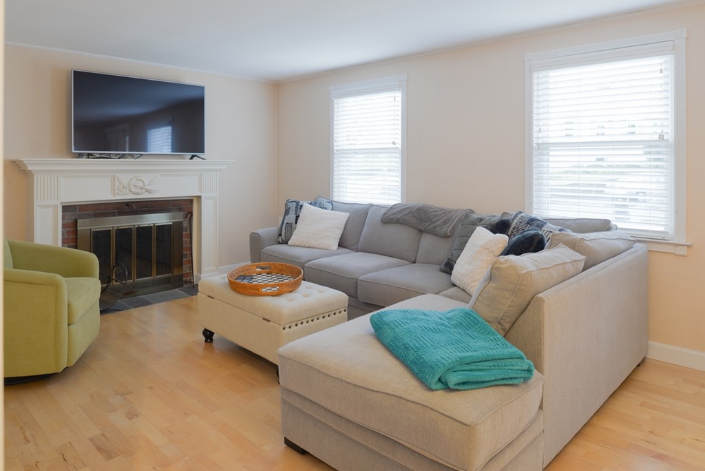 78 Moffatt Road Salem, MA 01970 - Photo 8 of 30 a living room with furniture a flat screen tv and a fireplace
