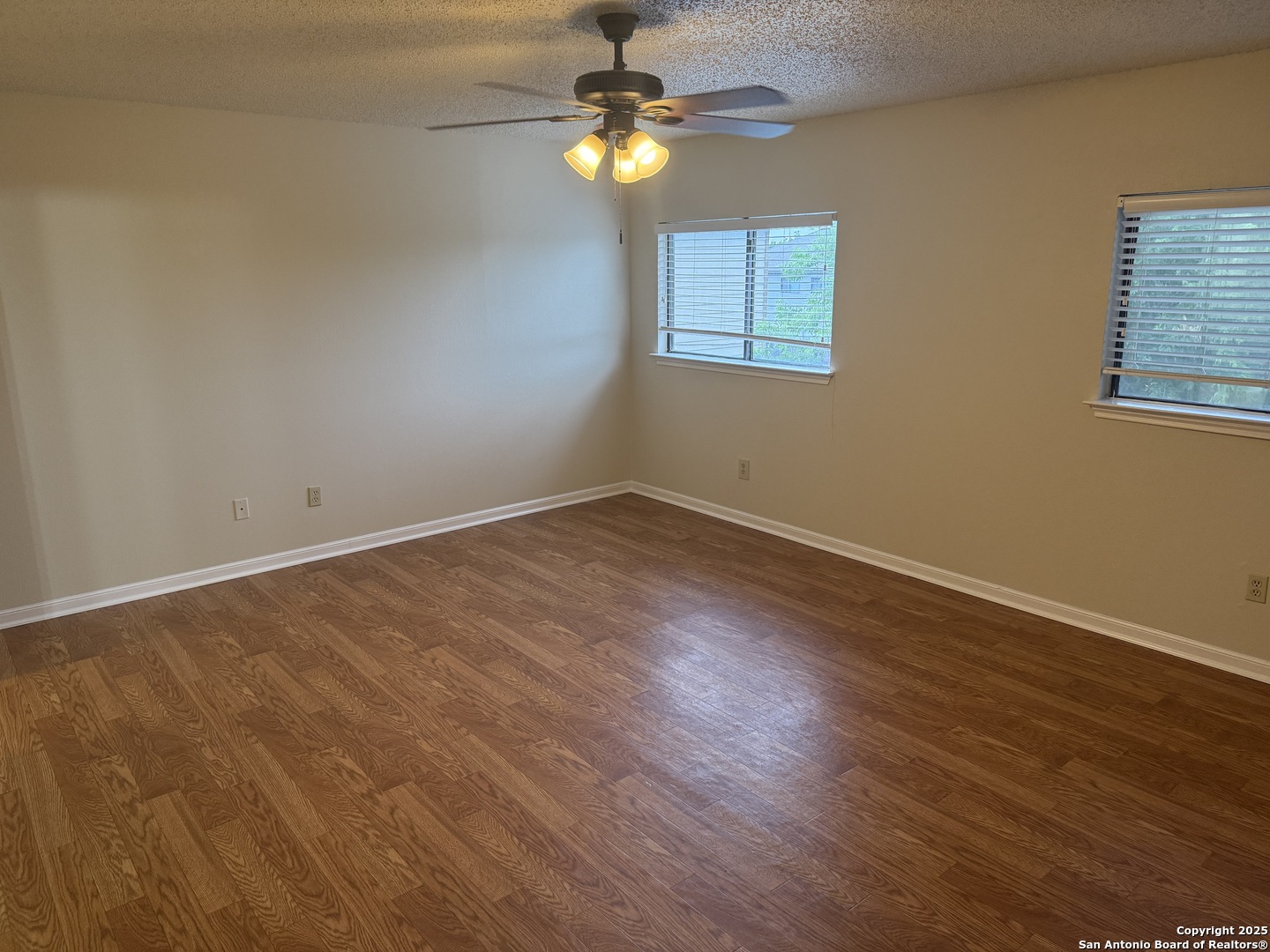 8022 Chestnut Clay Lane Converse, TX 78109 - Photo 12 of 21 a view of an empty room with window and wooden floor