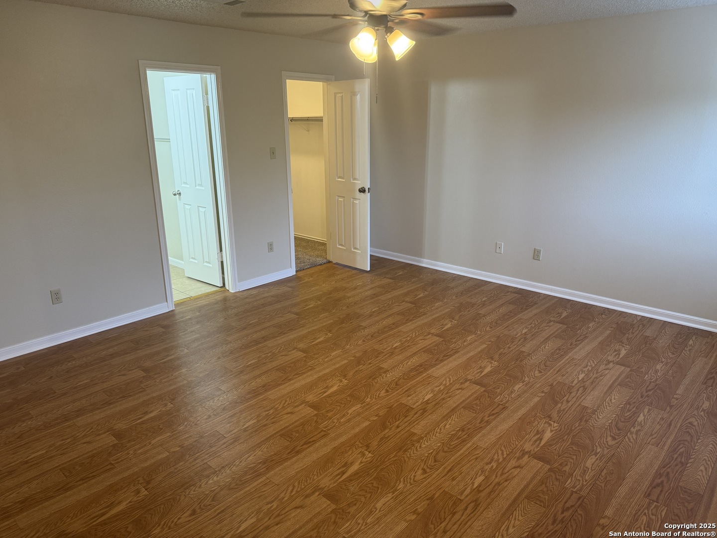 8022 Chestnut Clay Lane Converse, TX 78109 - Photo 14 of 21 an empty room with wooden floor and mirror