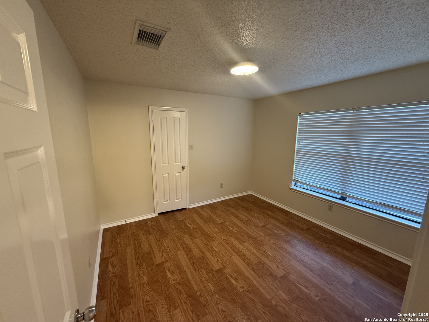 8022 Chestnut Clay Lane Converse, TX 78109 - Photo 17 of 21 a view of a room with a wooden floor and a window