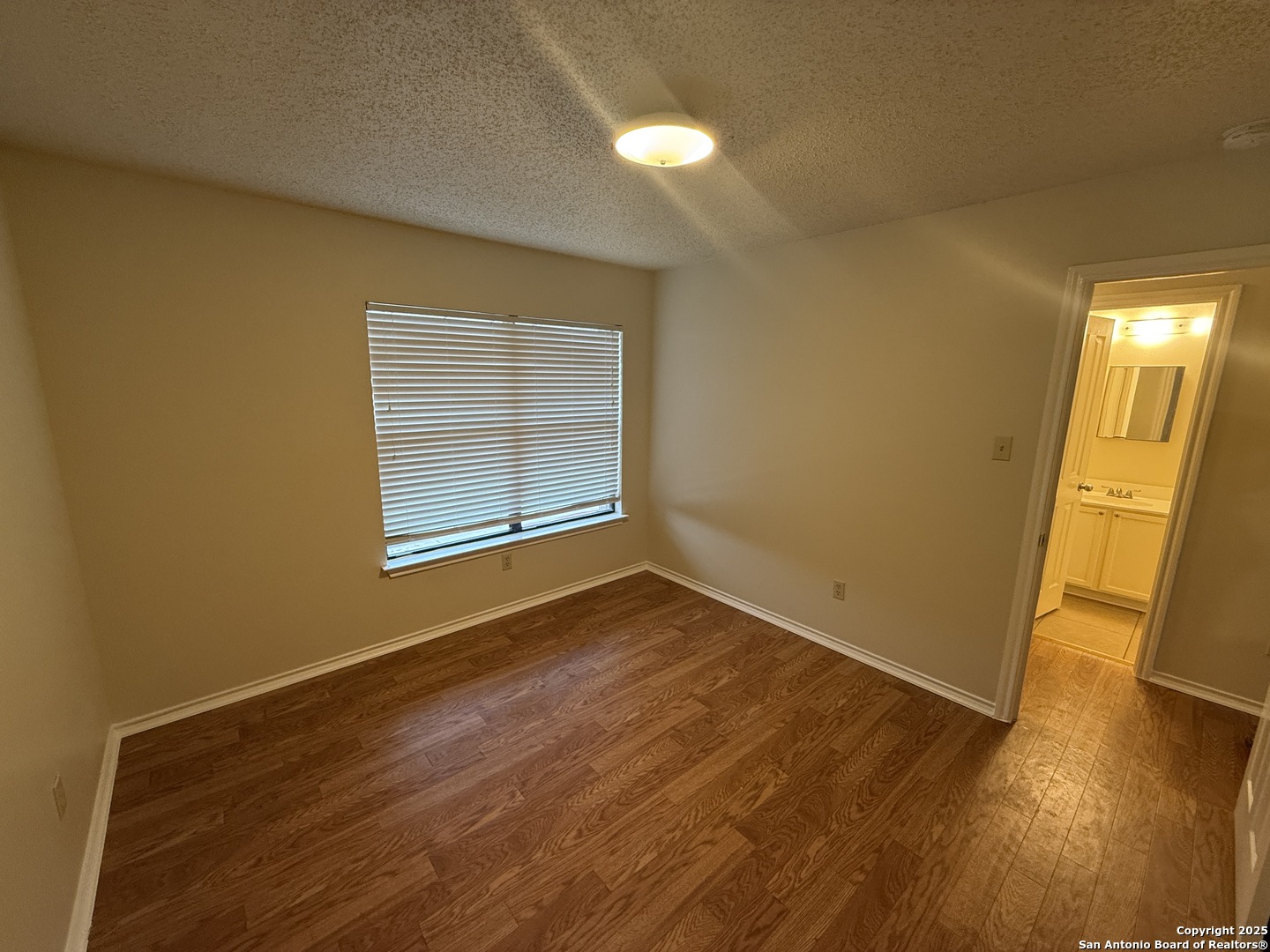 8022 Chestnut Clay Lane Converse, TX 78109 - Photo 18 of 21 a view of empty room with wooden floor and fan