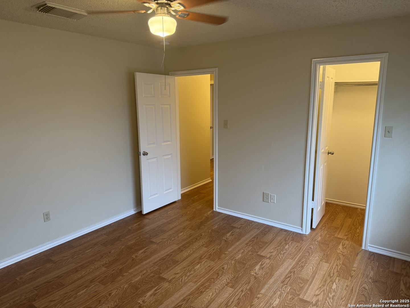 8022 Chestnut Clay Lane Converse, TX 78109 - Photo 19 of 21 a view of an empty room with wooden floor and a window