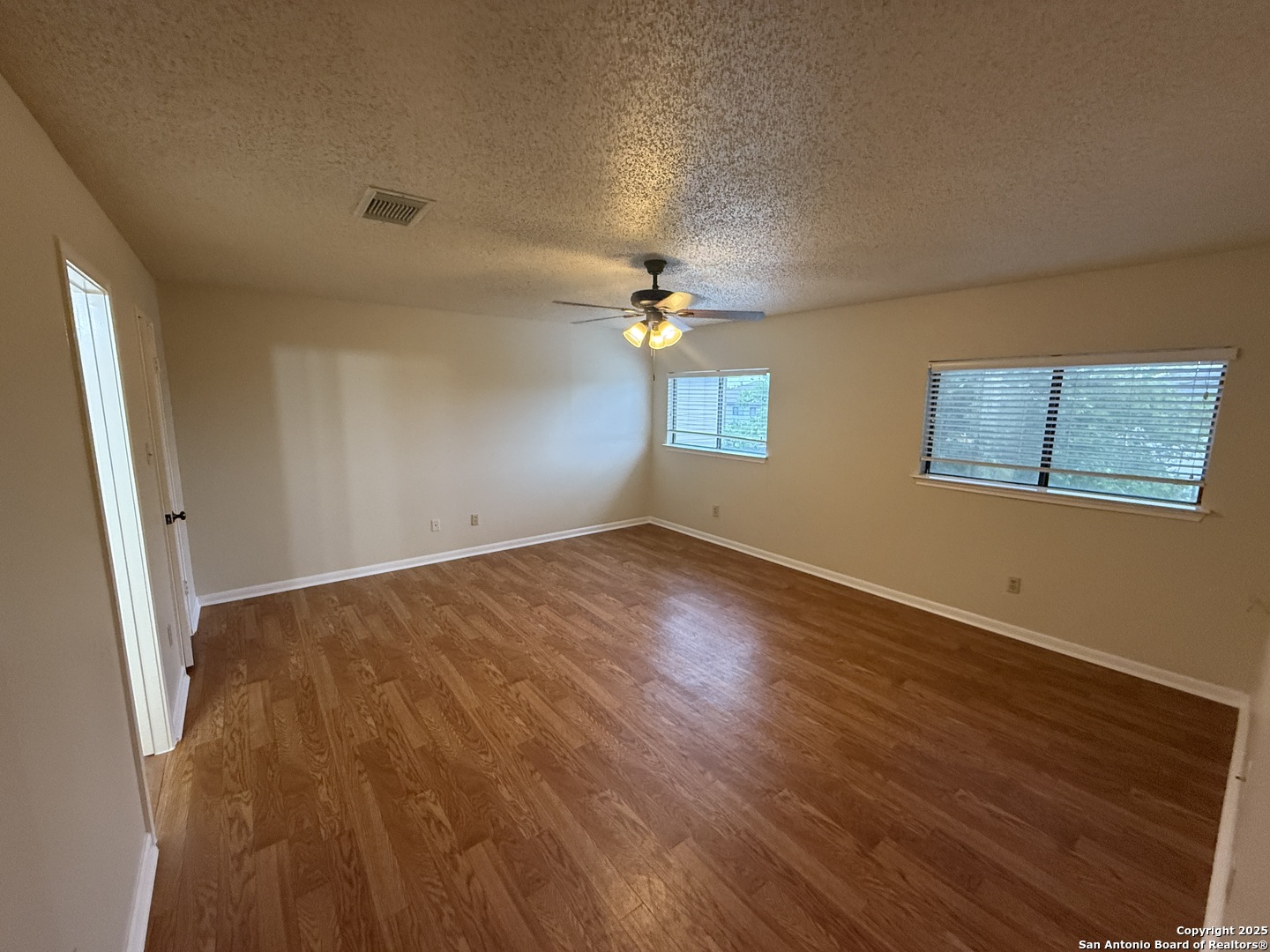 8022 Chestnut Clay Lane Converse, TX 78109 - Photo 20 of 21 wooden floor in an empty room with a window