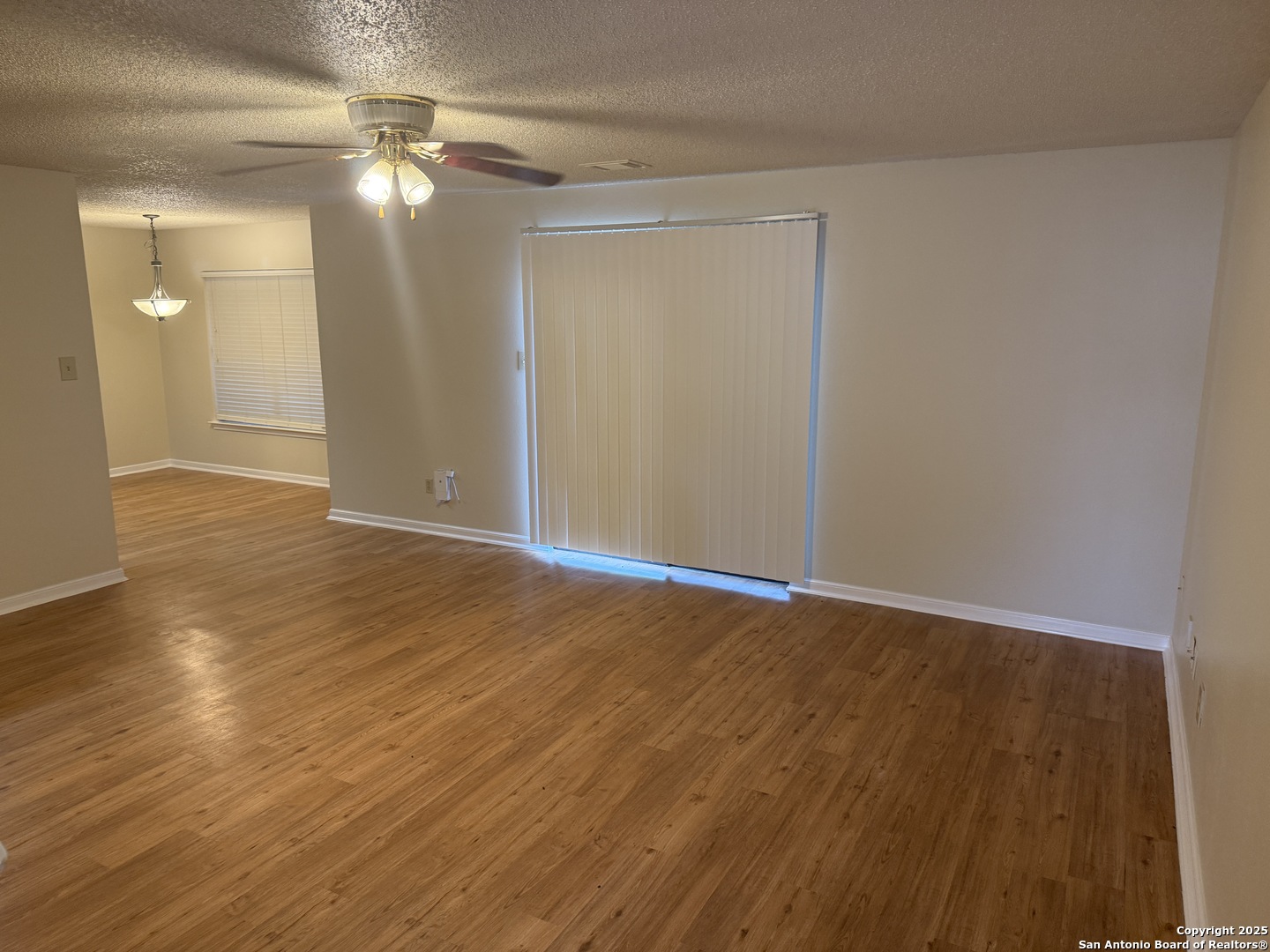 8022 Chestnut Clay Lane Converse, TX 78109 - Photo 4 of 21 a view of an empty room with wooden floor