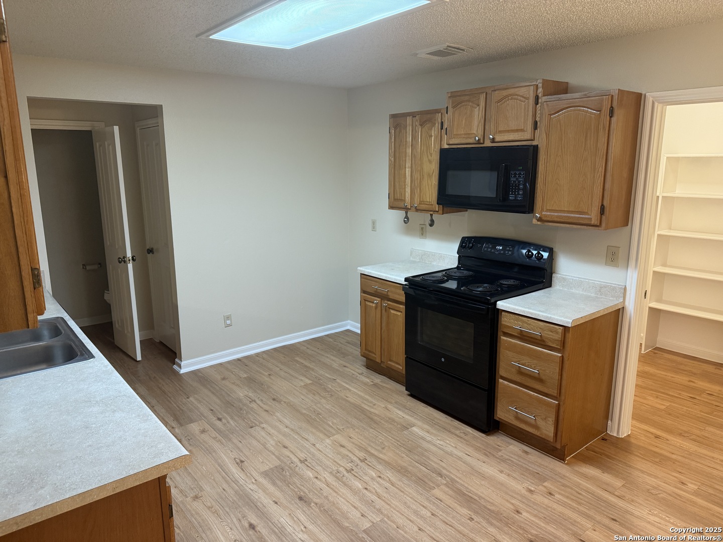 8022 Chestnut Clay Lane Converse, TX 78109 - Photo 5 of 21 a kitchen with stainless steel appliances granite countertop a stove and a microwave