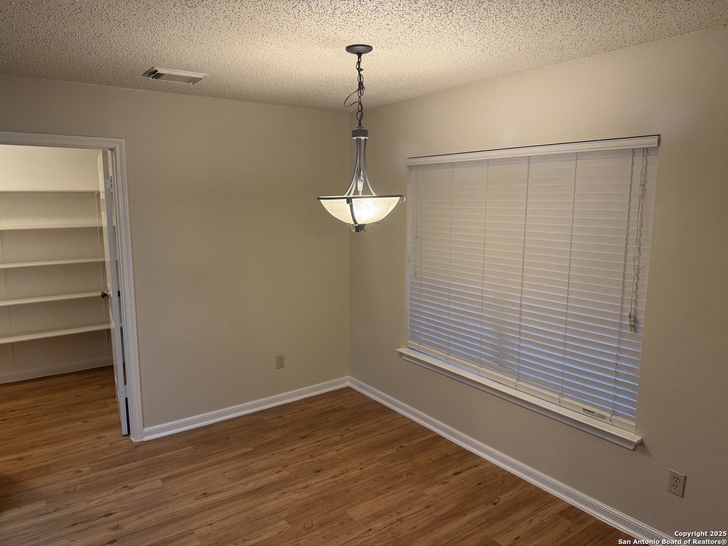 8022 Chestnut Clay Lane Converse, TX 78109 - Photo 6 of 21 a view of a room with wooden floor and a window
