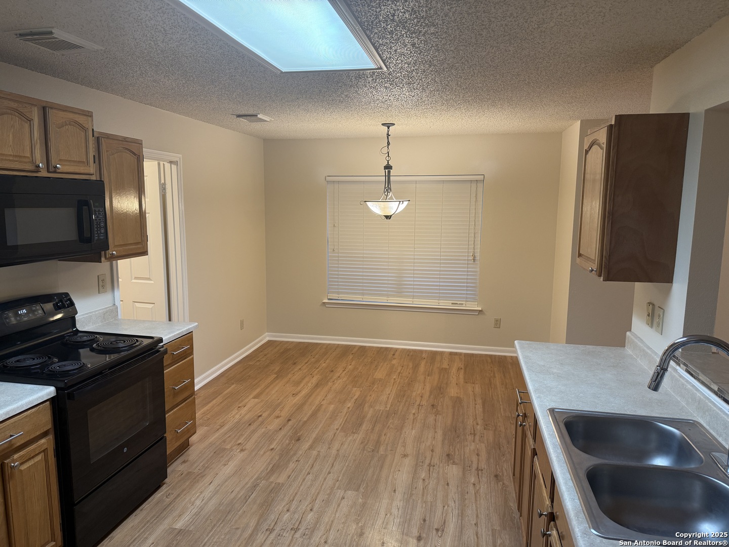 8022 Chestnut Clay Lane Converse, TX 78109 - Photo 7 of 21 a kitchen with a sink stove and refrigerator
