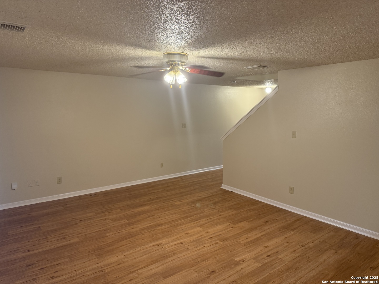 8022 Chestnut Clay Lane Converse, TX 78109 - Photo 8 of 21 a view of an empty room with wooden floor