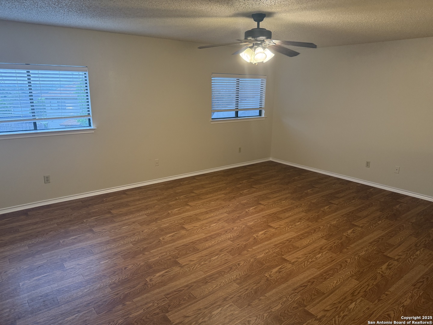 8022 Chestnut Clay Lane Converse, TX 78109 - Photo 9 of 21 a view of a room with wooden floor and chandelier fan