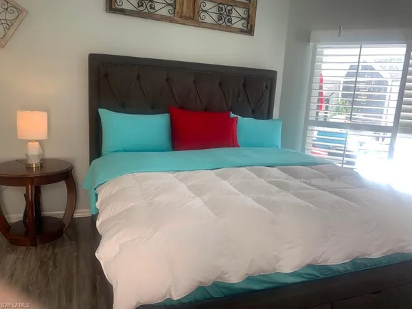 a bedroom with a bed and window