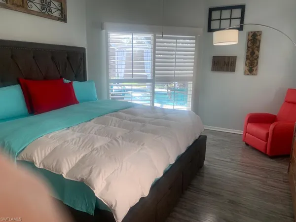 a bed sitting in a bedroom next to a window