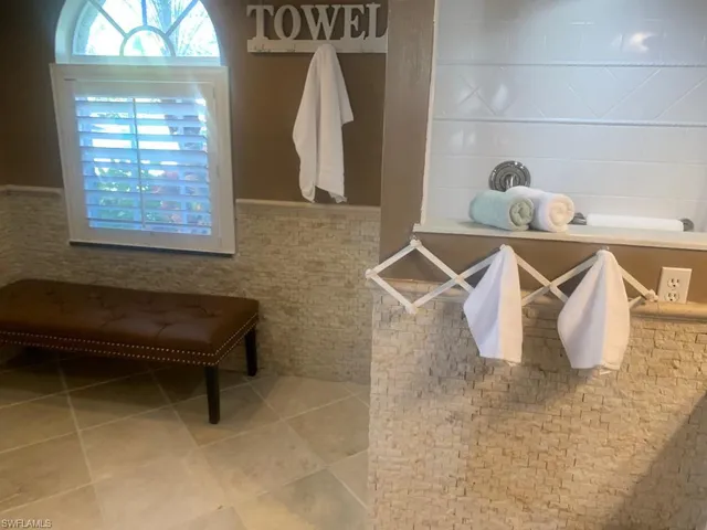 a bathroom with a window and a mirror