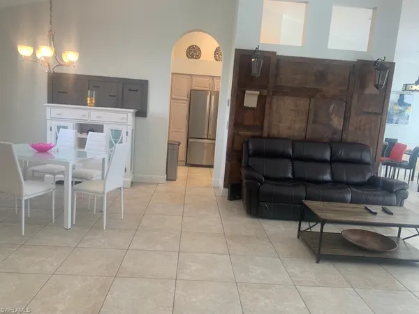 a kitchen with stainless steel appliances kitchen island granite countertop a refrigerator and a cabinets