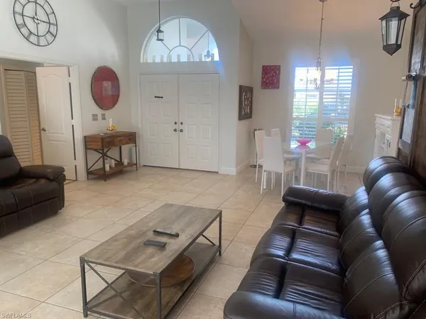 a living room with furniture a chandelier furniture and a window