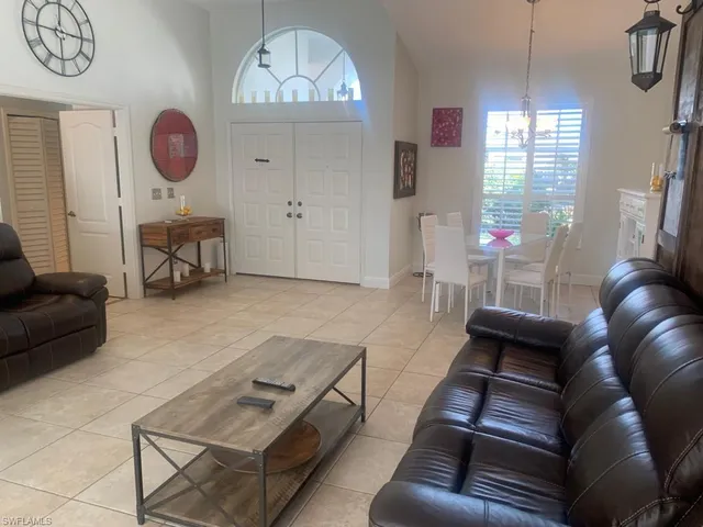 a living room with furniture a chandelier furniture and a window