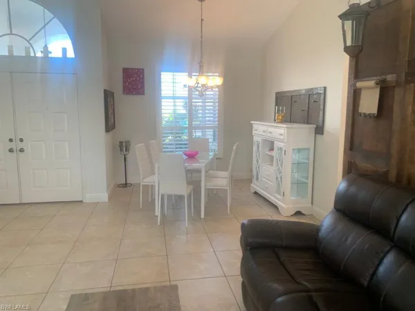 a living room with furniture a lamp and a chandelier