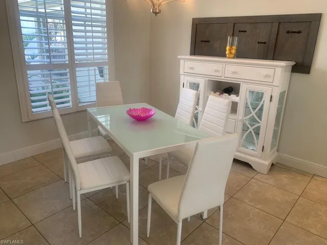 a dinning room with a table and chairs