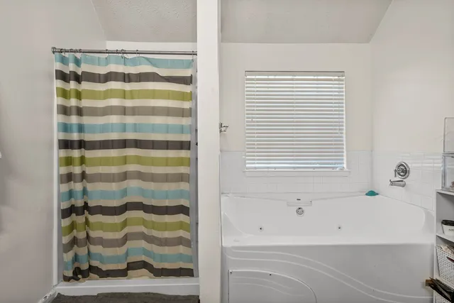 a view of walk in closet with clothes