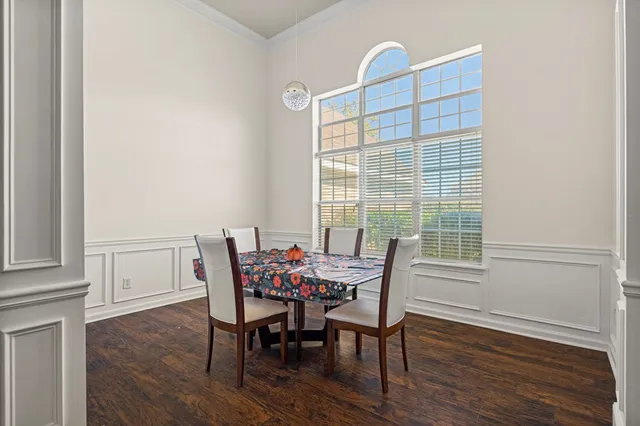 a dining room with furniture and wooden floor
