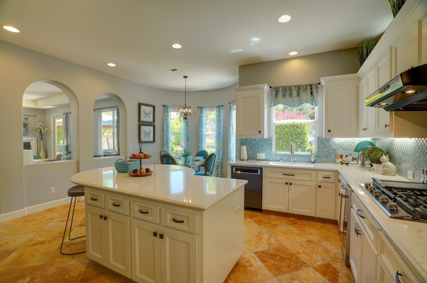 2860 Club Drive Gilroy, CA 95020 - Photo 21 of 87 a large kitchen with kitchen island a stove a sink a dining table and chairs