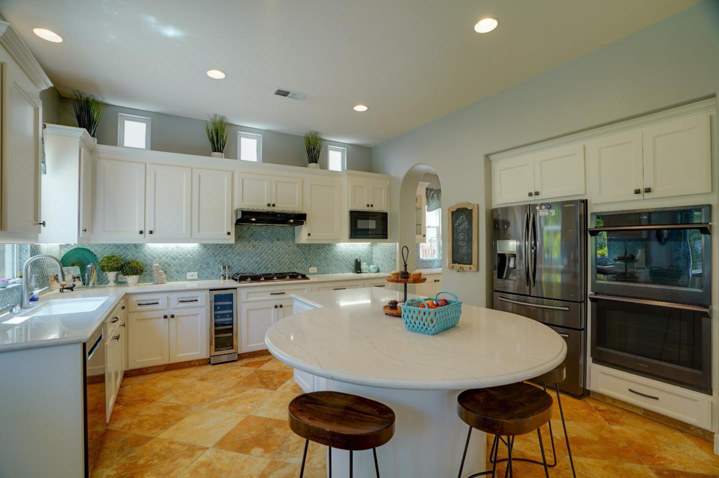 2860 Club Drive Gilroy, CA 95020 - Photo 24 of 87 a kitchen with stainless steel appliances granite countertop a stove a sink a refrigerator and white cabinets with wooden floor