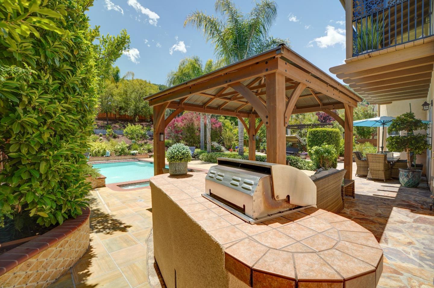 2860 Club Drive Gilroy, CA 95020 - Photo 69 of 87 a view of a patio with table and chairs potted plants with floor to ceiling window and potted plants