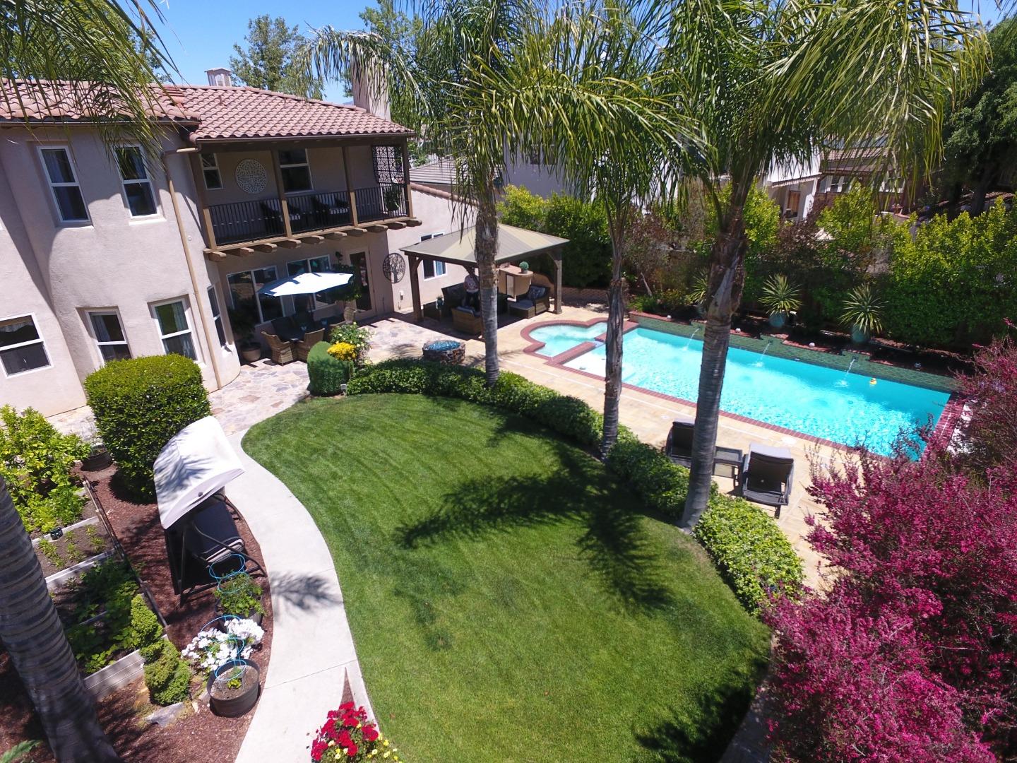 2860 Club Drive Gilroy, CA 95020 - Photo 83 of 87 a view of a patio with table and chairs potted plants and large tree