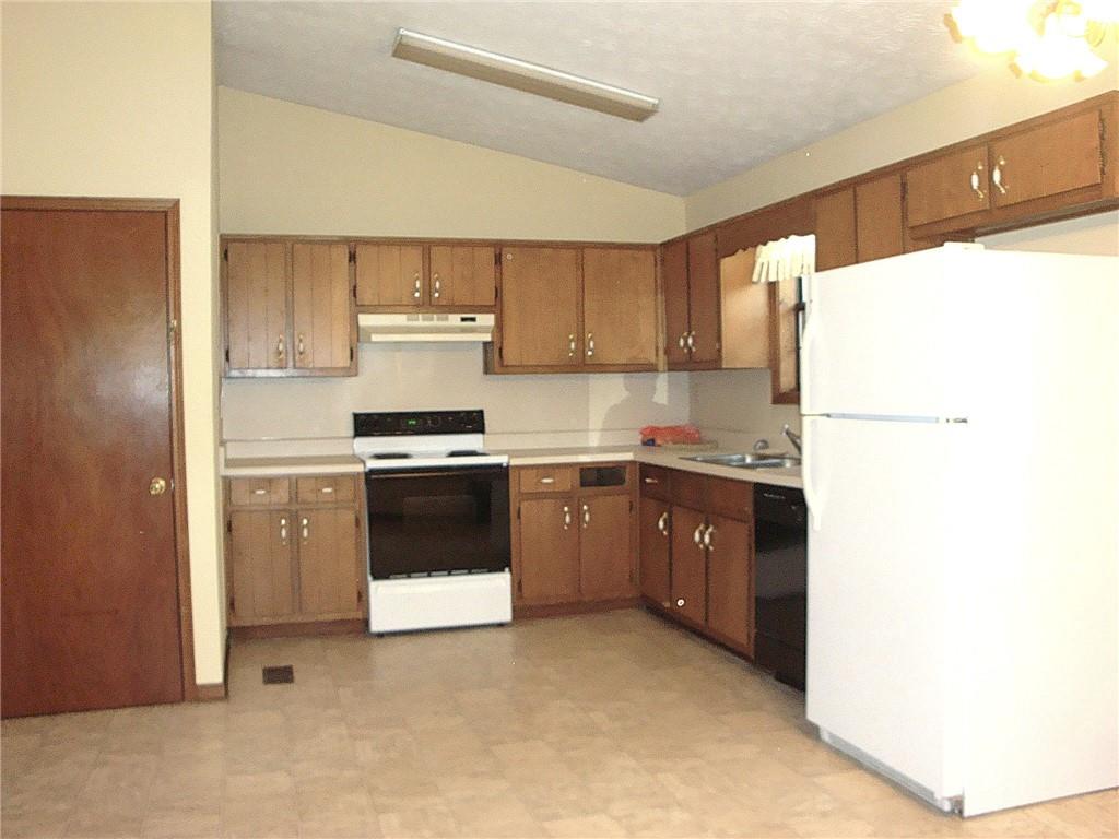 568 Russell Road Lawrenceville, GA 30043 - Photo 3 of 20 a kitchen with a refrigerator and a stove