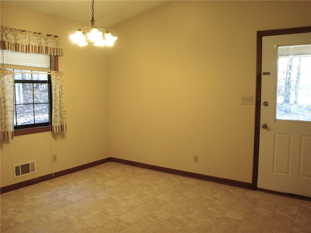 568 Russell Road Lawrenceville, GA 30043 - Photo 5 of 20 an empty room with chandelier fan